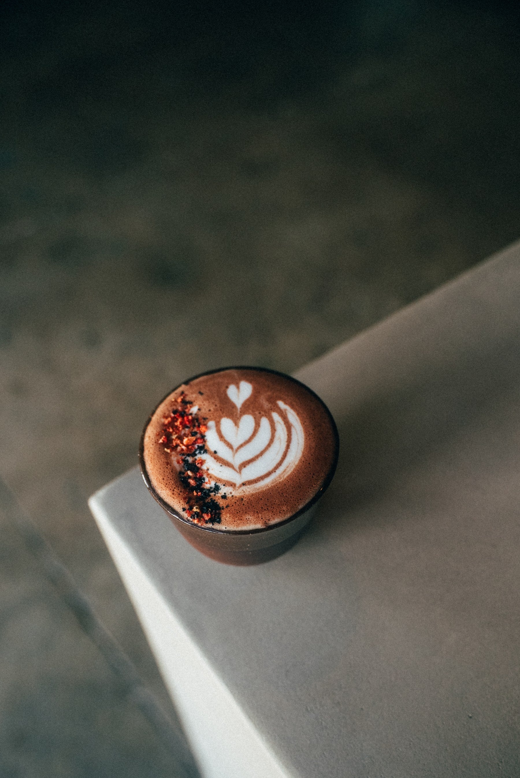 Hot chocolate with latte art and red flake garnish