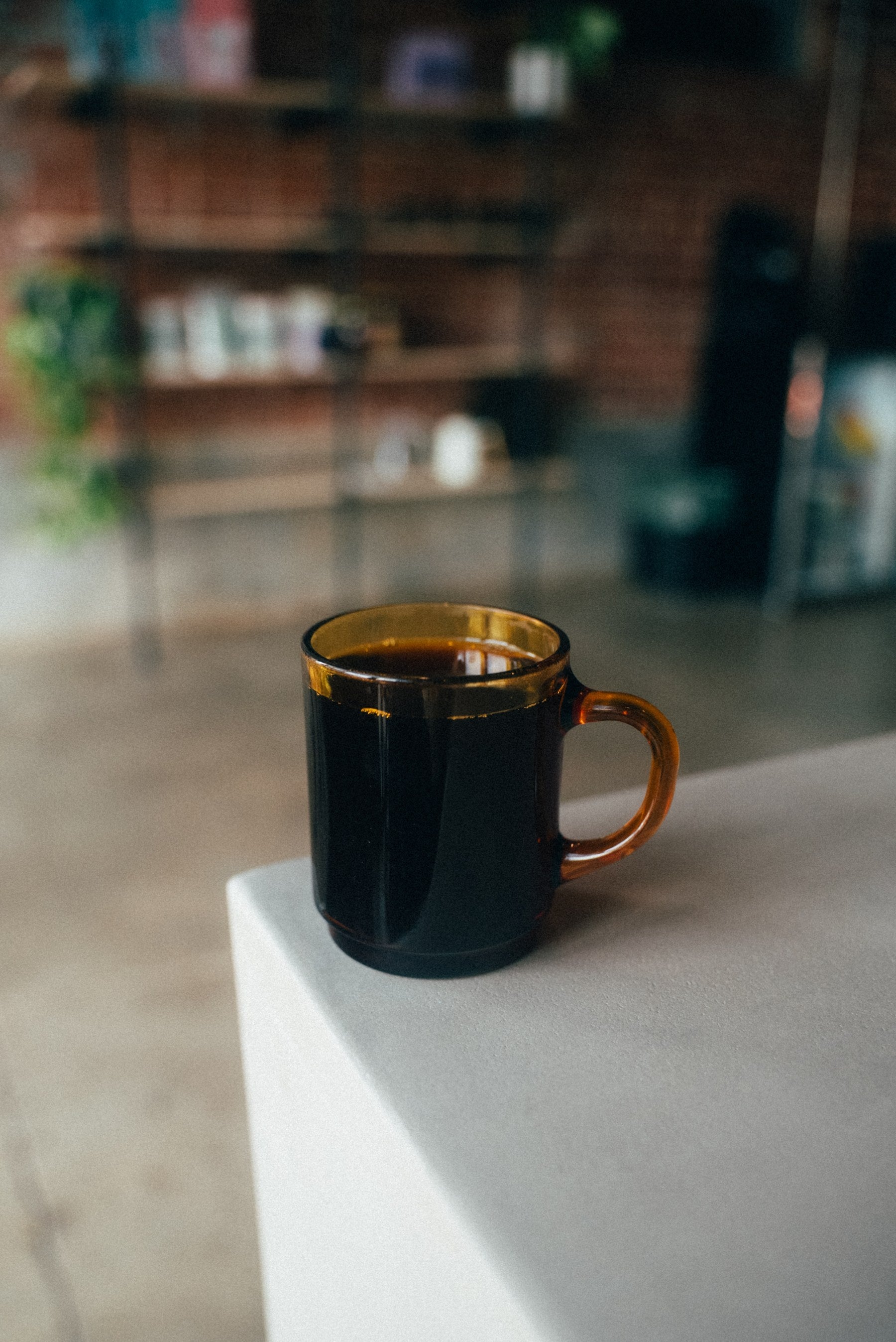 Hot coffee in an amber glass mug